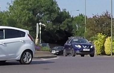 car leaving roundabout