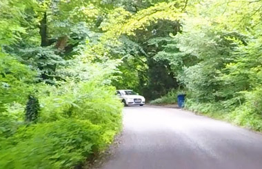 Car emerging on a country road