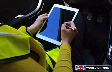Examiner using an ipad on the driving test